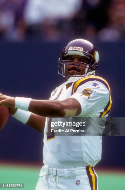 Quarterback Warren Moon of the Minnesota Vikings passes the ball in the game between the Minnesota Vikings vs the New York Giants at Giants Stadium...