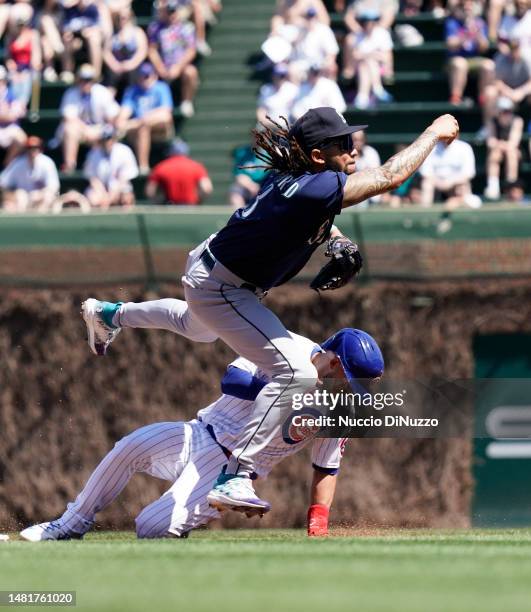 Crawford of the Seattle Mariners throws to first base as Nick Madrigal of the Chicago Cubs is out on a fielder's choice during the first inning at...