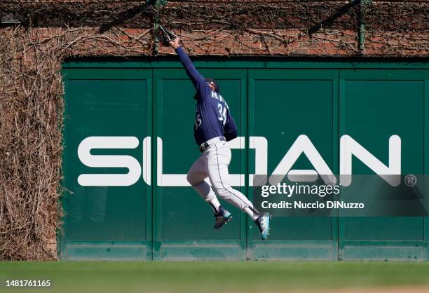 Teoscar Hernandez of the Seattle Mariners catches the fly out by Eric Hosmer of the Chicago Cubs during the seventh inning at Wrigley Field on April...