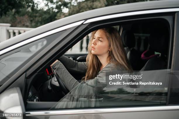 anxious woman driving with depression - police road block stock pictures, royalty-free photos & images