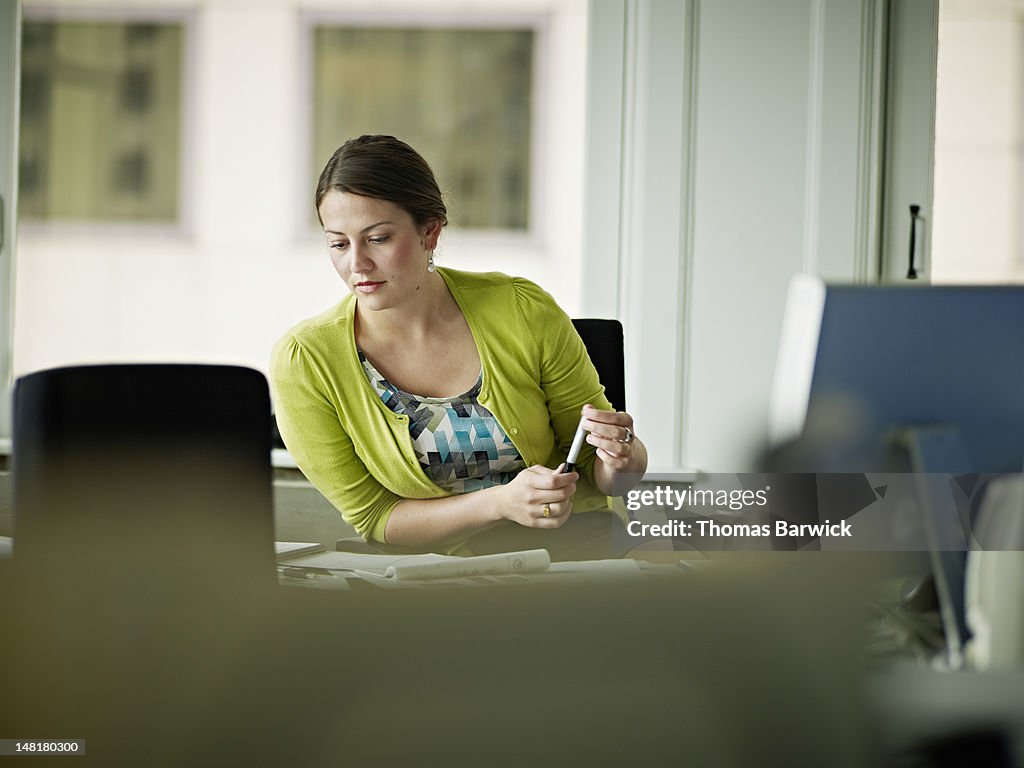 Businesswoman sitting at desk in office