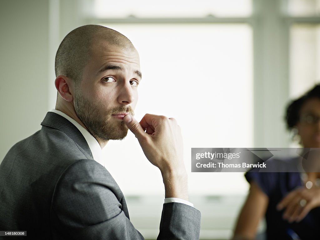 Businessman in office looking over shoulder