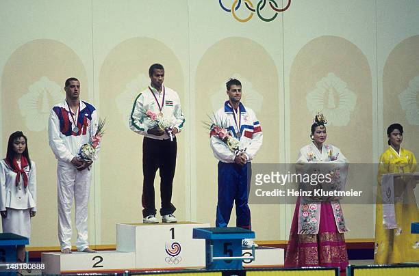 Summer Olympics: USA Matt Biondi with silver medal, Suriname Anthony Nesty with gold medal, and Great Britain Andy Jameson with bronze medal after...