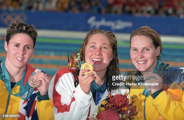 Summer Olympics: Australia Petria Thomas, USA Misty Hyman, and Australia Susie O'Neill victorious with medals after Women's 200M Butterfly Final at...