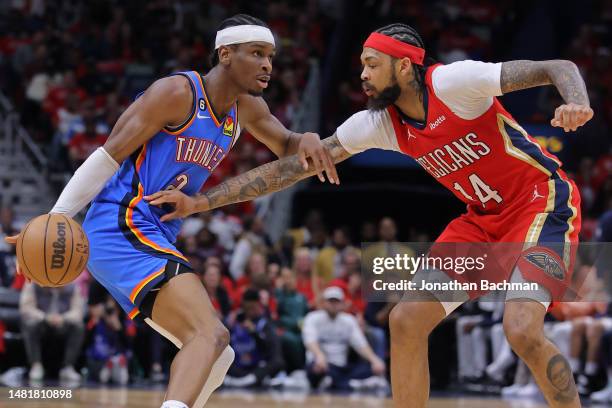 Shai Gilgeous-Alexander of the Oklahoma City Thunder drives against Brandon Ingram of the New Orleans Pelicans during the first half at the Smoothie...