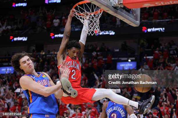 Josh Richardson of the New Orleans Pelicans dunks as Josh Giddey of the Oklahoma City Thunder defends during the second half at the Smoothie King...
