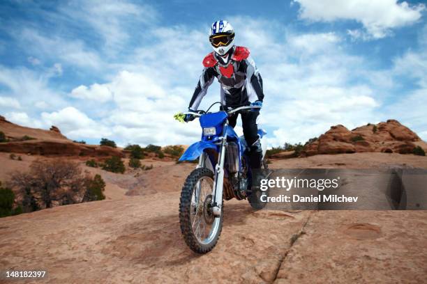 bike on a red rock bike on a red rock - rock scrambling stock pictures, royalty-free photos & images