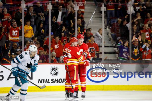 Nikita Zadorov of the Calgary Flames celebrates his hat trick in the third period against San Jose Sharks with teammate MacKenzie Weegar of the...