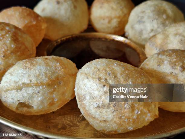 close-up of whole wheat panipuri/golgappa in a copper plate - pani_puri stock pictures, royalty-free photos & images