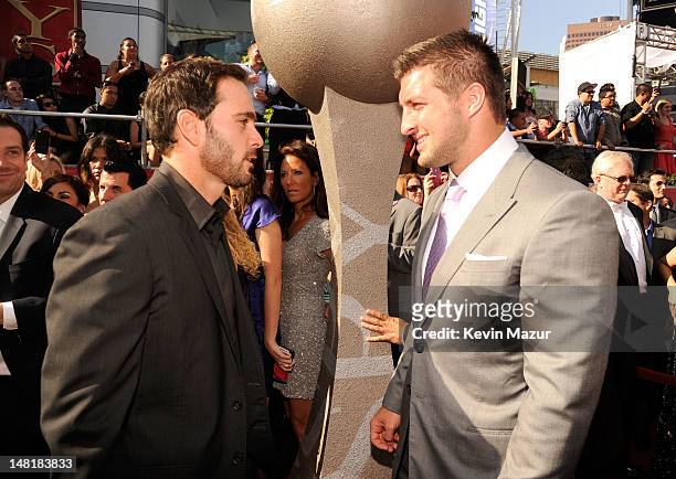 Nascar driver Jimmie Johnson and NFL player Tim Tebow of the New York Jets arrive at the 2012 ESPY Awards at Nokia Theatre L.A. Live on July 11, 2012...