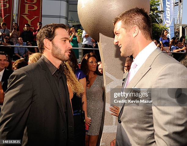 Nascar driver Jimmie Johnson and NFL player Tim Tebow of the New York Jets arrive at the 2012 ESPY Awards at Nokia Theatre L.A. Live on July 11, 2012...