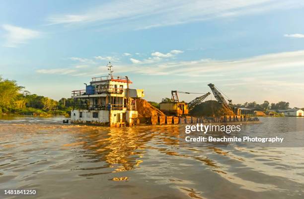 a scow / barge plying the rajang river on a sunny morning in sarawak, malaysia - sibu river stock pictures, royalty-free photos & images