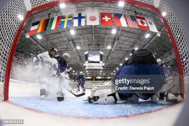 Defender Sophie Leclerc of France battles in front of the net against forward Kiira Yrjanen of Finland during the 2023 IIHF Women's World...