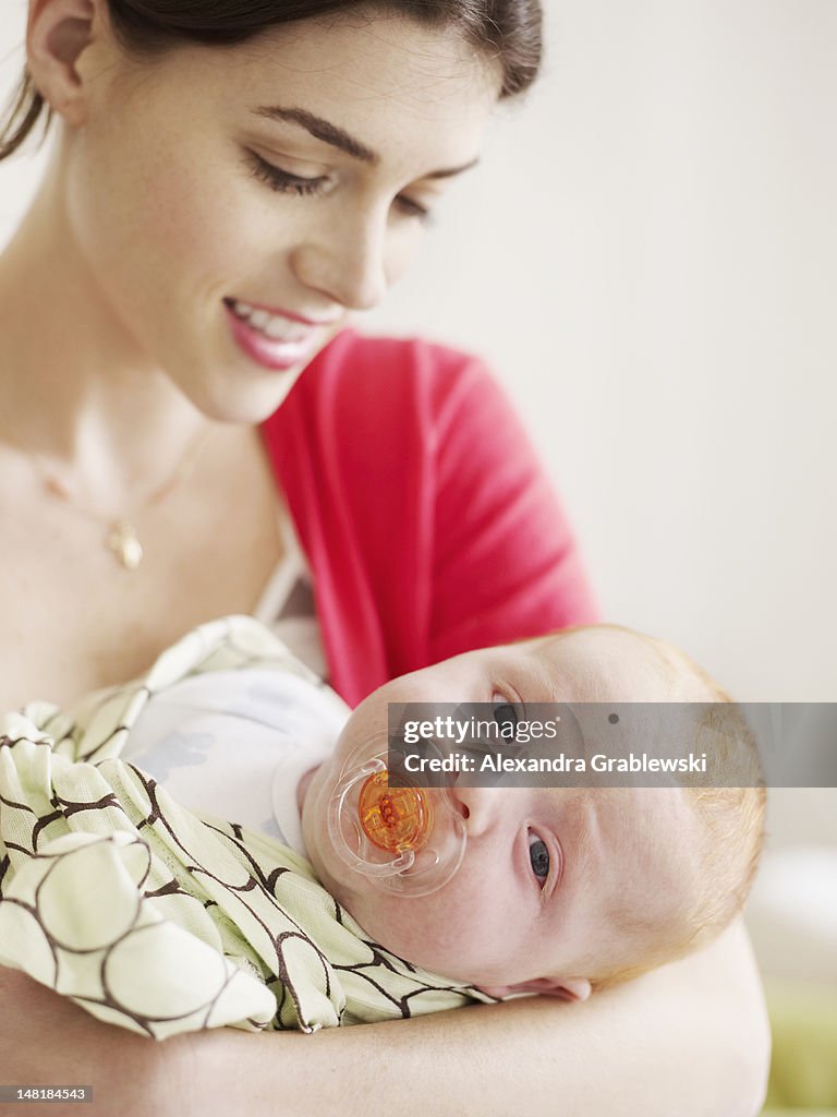 Mother Holding Baby with Pacifier