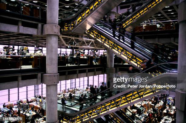 Underwriters, members and names at work on trading floors linked by escalators in the new Lloyd's Building, home of Lloyd's of London insurance...