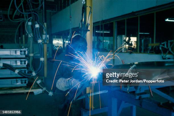 An auto worker welds the bodyshell of a car at a car factory in Mombasa, south eastern Kenya in East Africa in 1988.