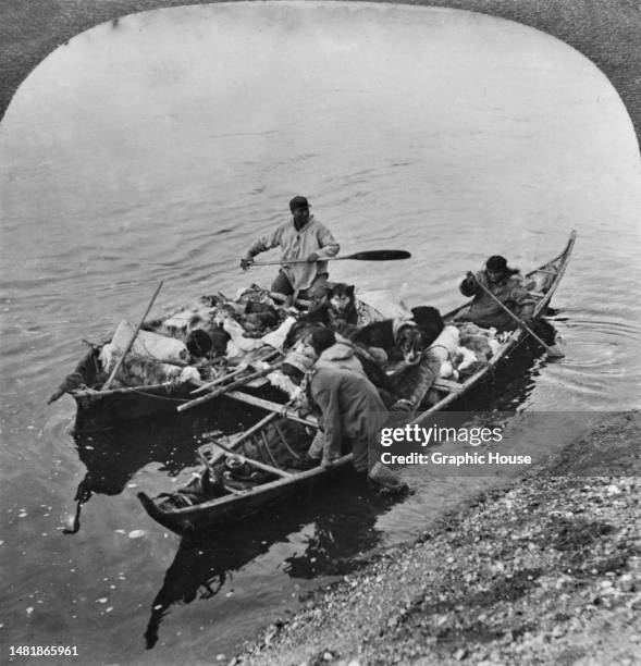 Mahlemut , Inuit tribespeople, their possessions loaded into kayaks as they move camp, possibly on the shores of Kotzebue Sound in northwestern...