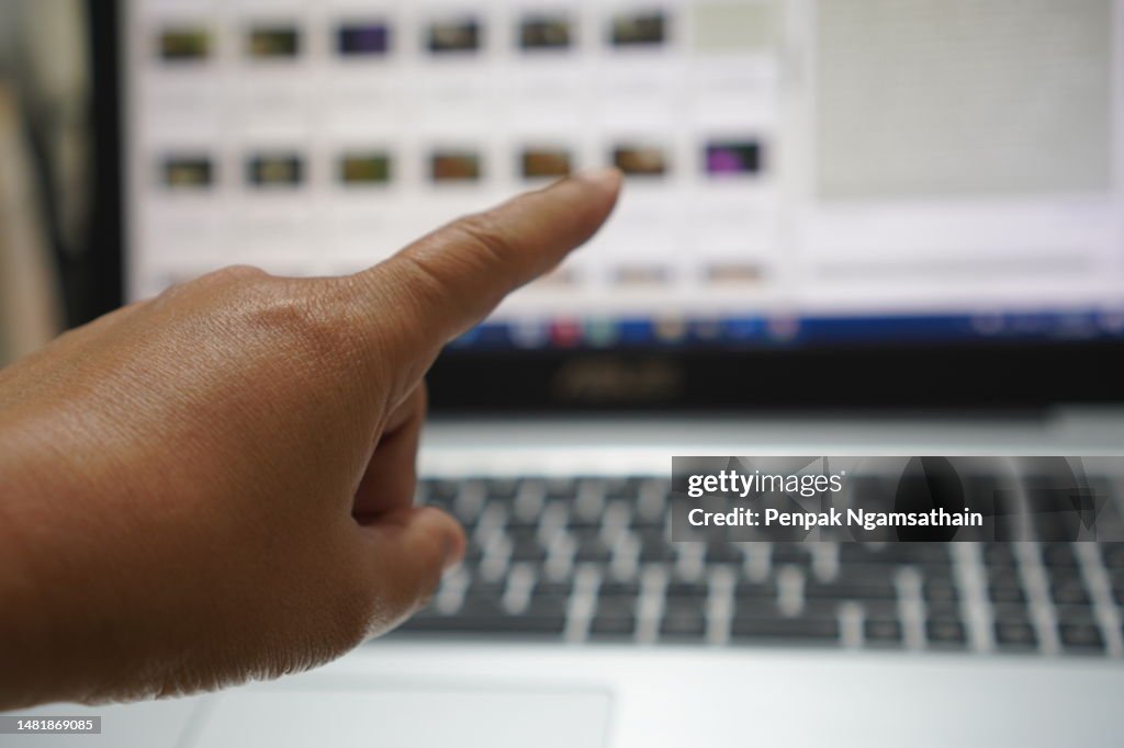 Close up Asian female 15-20 age hand pointing with index finger touching or pressing, sign arm and hand