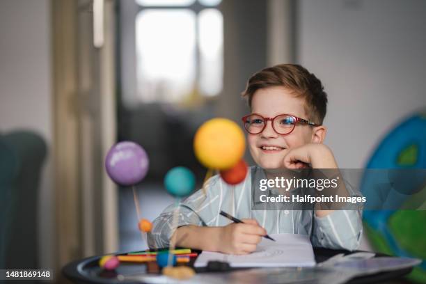 happy boy doing his school project. - school project stock pictures, royalty-free photos & images