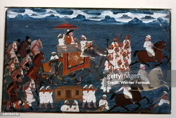 An official of the British East India Company riding on an elephant with an escort of foot soldiers and mounted Indian retainers, India. Indian. End...
