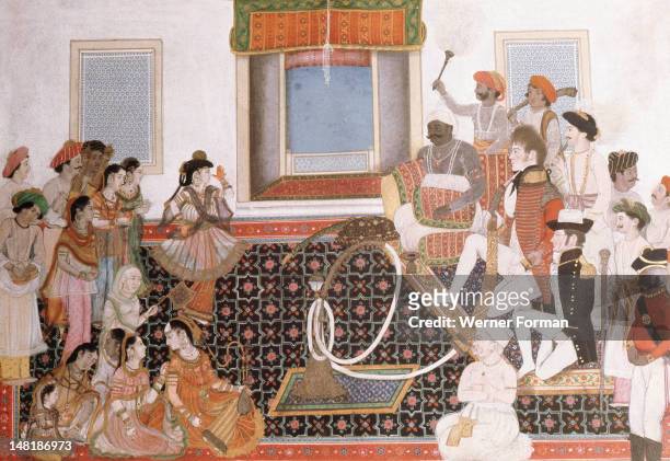 Officers of the British East India Company being entertained by musicians and dancers, One of the European officers smokes a large hookah. India....