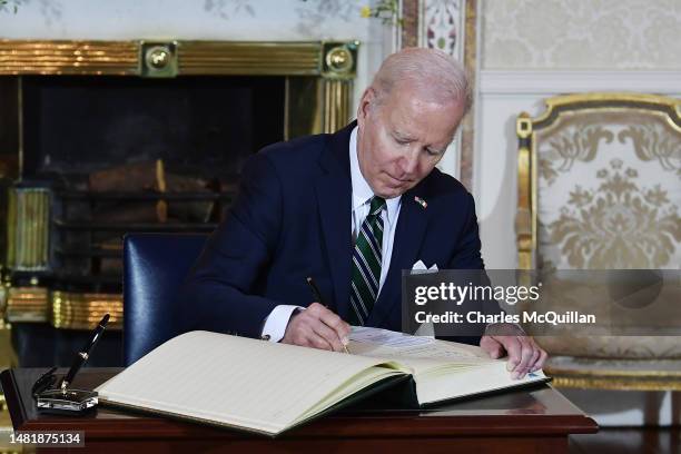 President Joe Biden signs the visitors book at the Irish President's official residence Áras an Uachtaráin on April 13, 2023 in Dublin, Ireland. US...