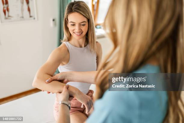 i will make pressure here ,tell me if you feel any pain - wrist stock pictures, royalty-free photos & images