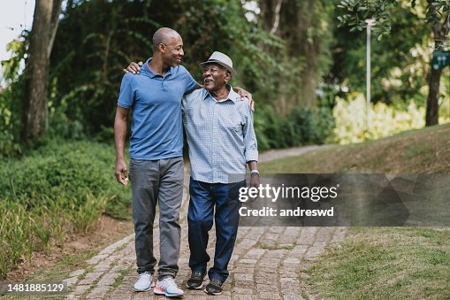 Portrait of elderly father and adult son walking