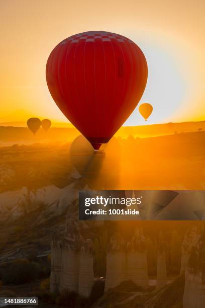 hot air balloons at love valley in cappadocia - cave fire stock pictures, royalty-free photos & images