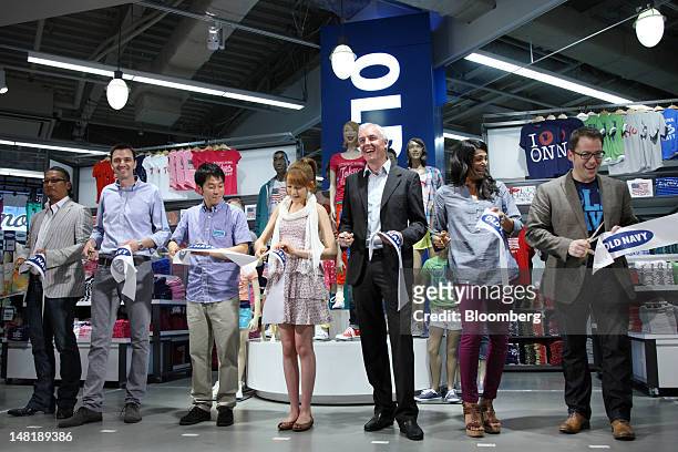 Stephen Sunnucks, international president of Gap Inc., third from right, attends a ribbon cutting ceremony during the opening of the Old Navy shop in...