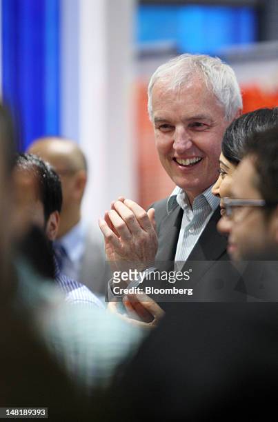 Stephen Sunnucks, international president of Gap Inc., claps as customers arrive at the Old Navy shop in Tokyo, Japan, on Thursday, July 12, 2012....