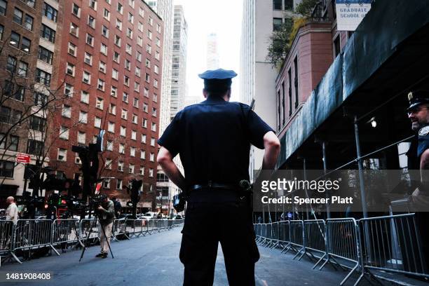 Police, media and protesters gather around the offices of New York’s Attorney General as former president Donald Trump is scheduled to arrive for his...