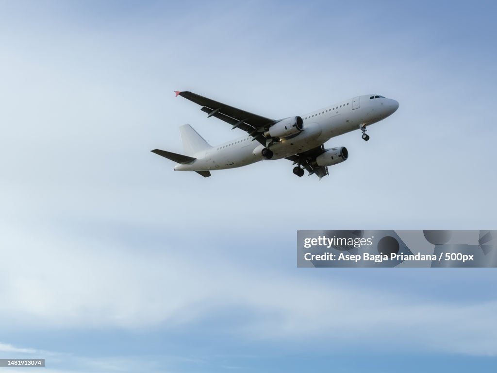 Low angle view of airplane flying against sky,Tallinn Airport,Estonia