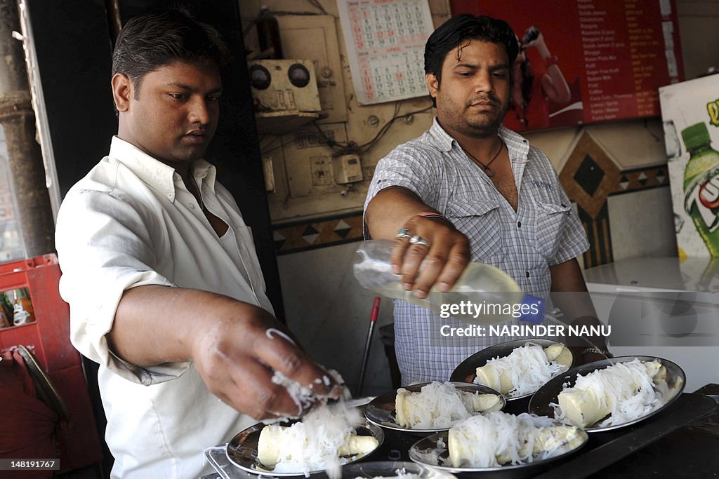 Indian workers prepare dishes of Matka K
