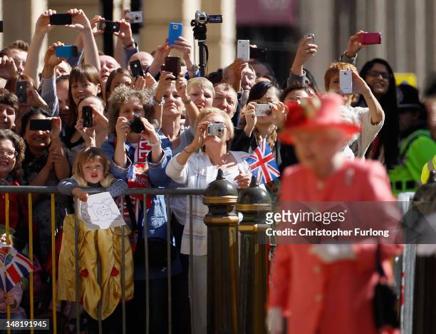 Wellwishers clamour to see and photograph Queen Elizabeth II at Victoria Square, Birmingham during her Diamond Jubilee visit to the City on July 12,...