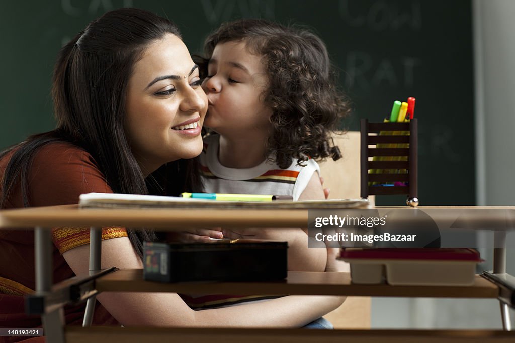 Schoolgirl (2-3) kissing teacher