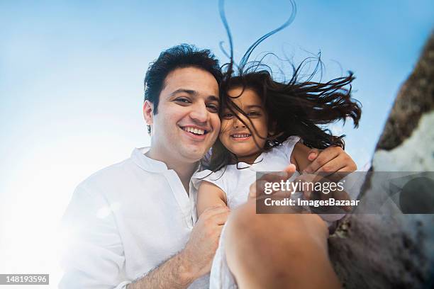 low angle portrait of father with daughter (6-7) - south asia stock pictures, royalty-free photos & images