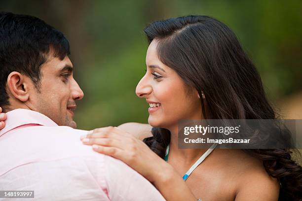 young couple face to face outdoors - imagesbazaar stock pictures, royalty-free photos & images