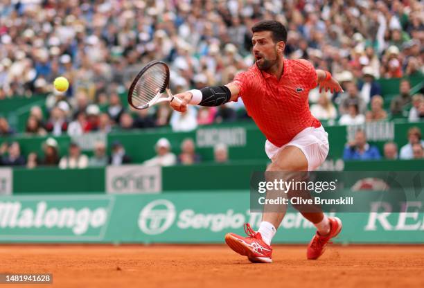 Novak Djokovic of Serbia plays a backhand against Lorenzo Musetti of Italy in their third round match during day five of the Rolex Monte-Carlo...