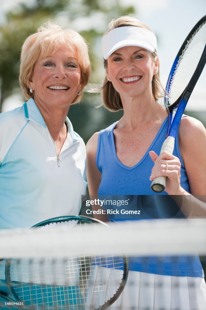 Caucasian women playing tennis