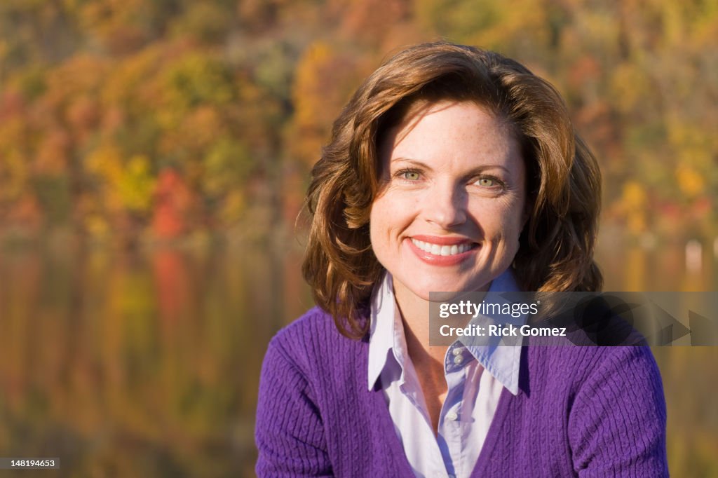 Smiling Caucasian woman outdoors in autumn