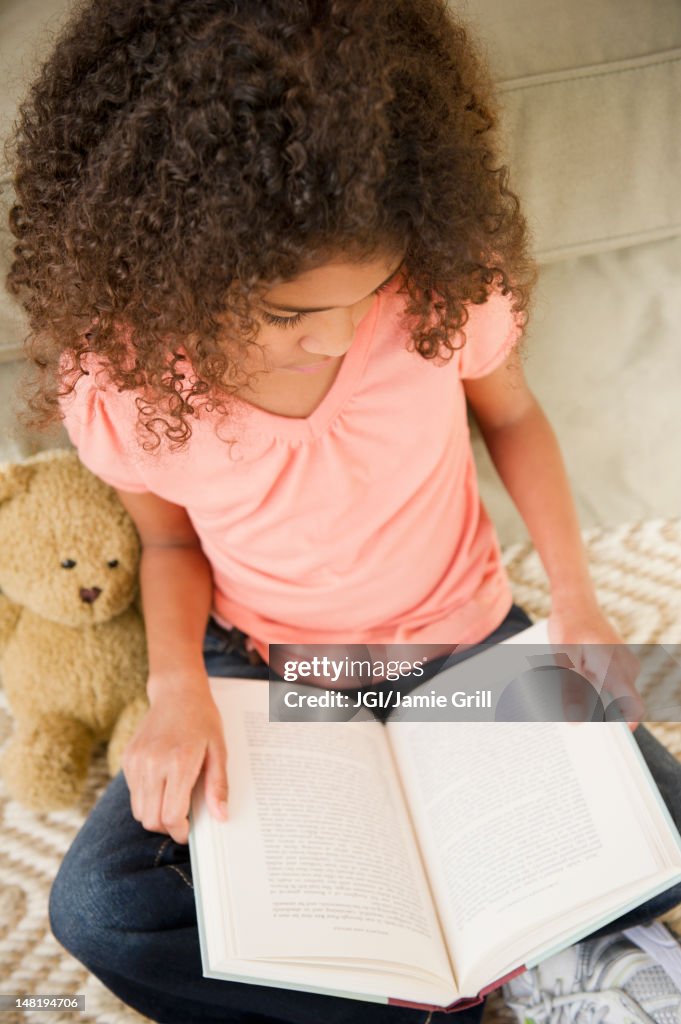 Mixed race girl reading book