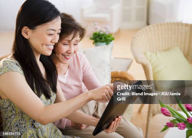japanese mother and daughter using digital tablet - japanese family ストックフォトと画像