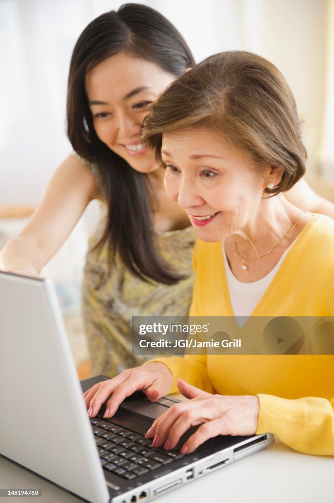 Japanese mother and daughter using laptop together