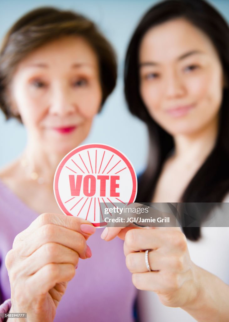 Japanese mother and daughter holding vote sticker