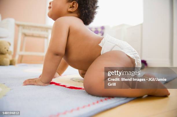 black baby girl crawling on floor - crawling stock pictures, royalty-free photos & images