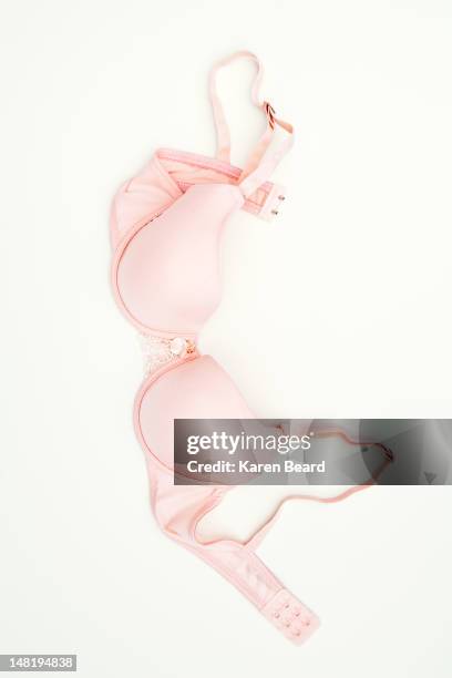 pink bra laying on ground - ブラジャー ストックフォトと画像