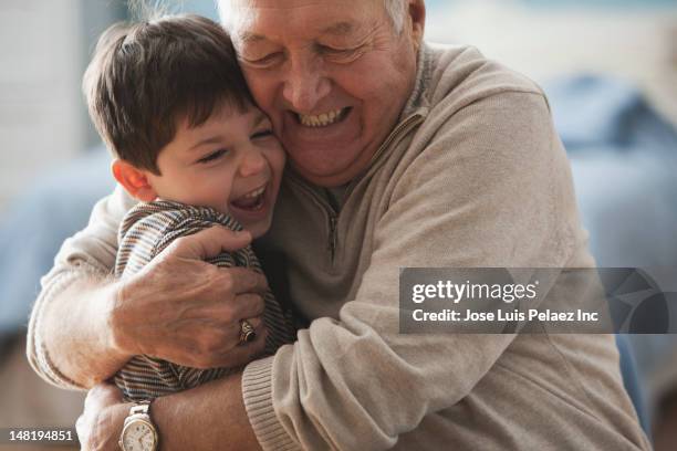 caucasian man hugging grandson - embracing child stock pictures, royalty-free photos & images