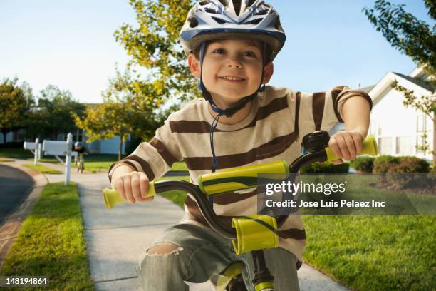 caucasian boy riding bicycle on sidewalk - 4 5 jahre stock-fotos und bilder