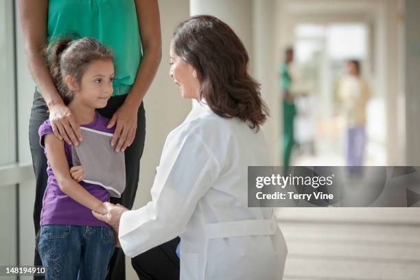 doctor talking to mother and daughter - broken trust stock pictures, royalty-free photos & images